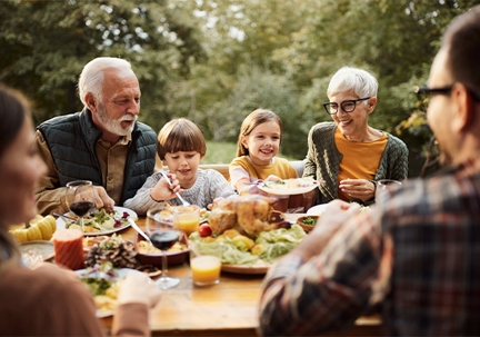 Multigenerational family eating outside