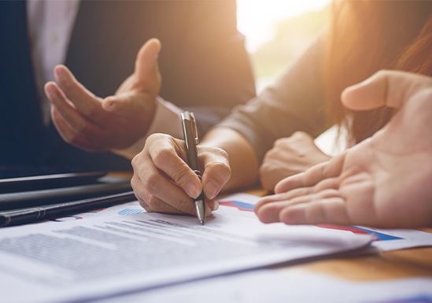 People signing paperwork