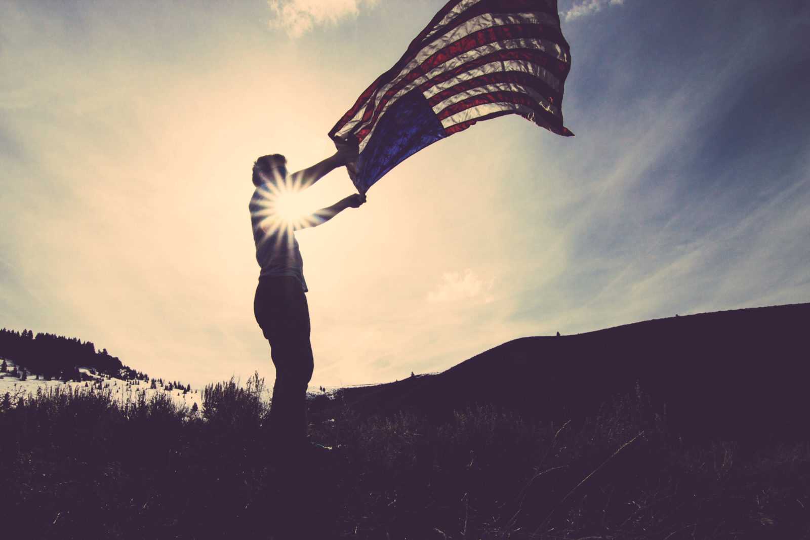 man holding U.S flag